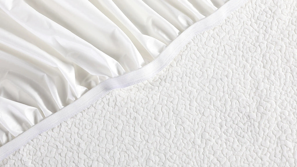 a close up of a white bed sheet