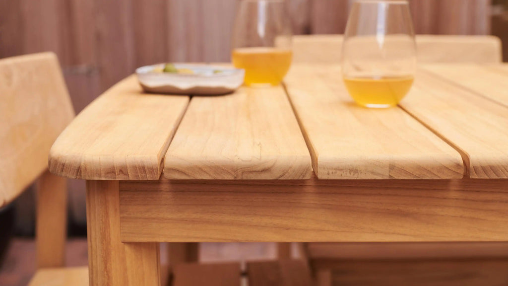 wooden table with two glasses on it