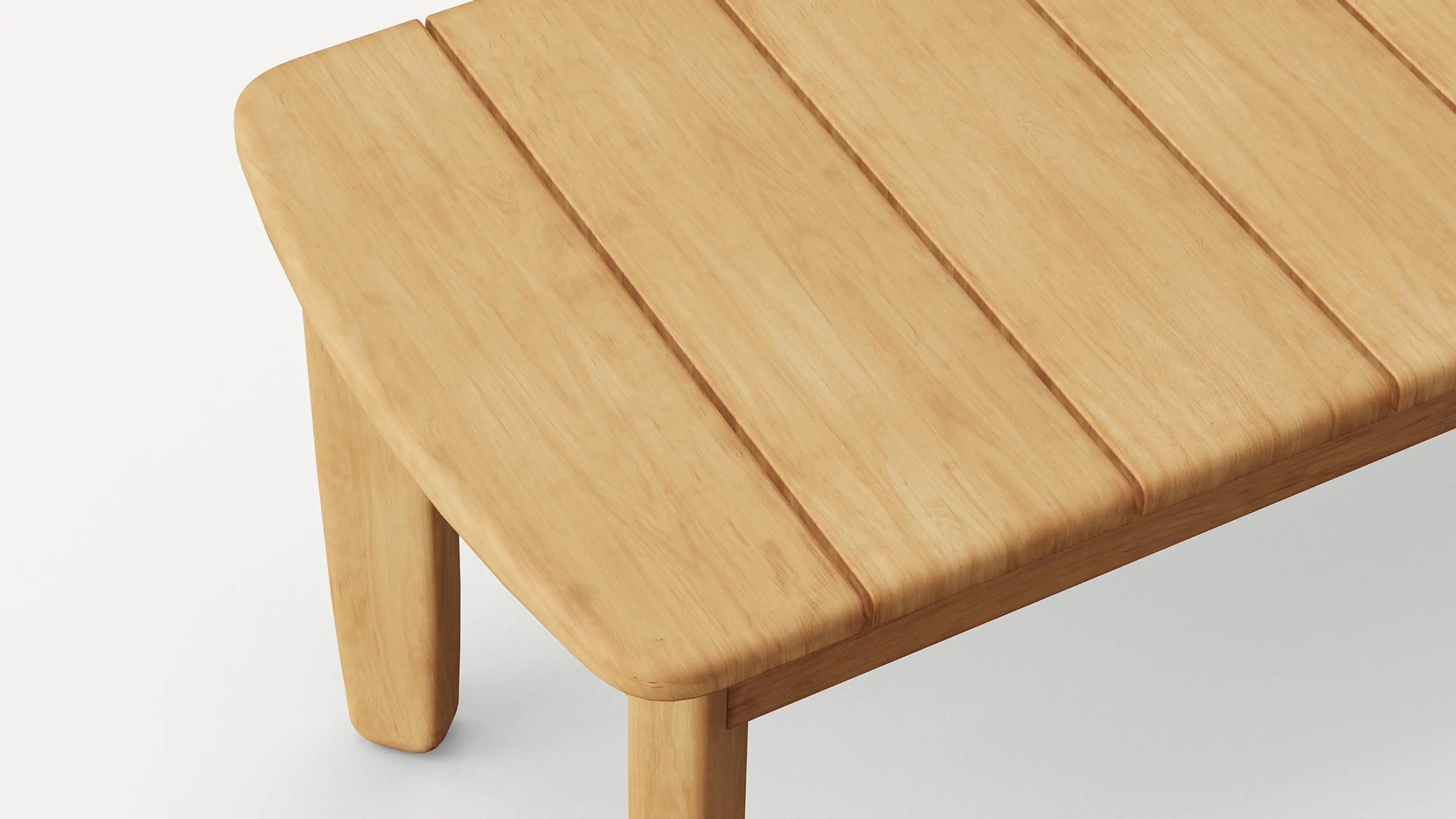 Close-up of a light wood rectangular table corner with three slatted planks and rounded edges and legs.