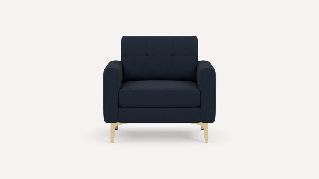 Front view of a modern navy blue armchair with square armrests and light wooden legs on a plain white background.
