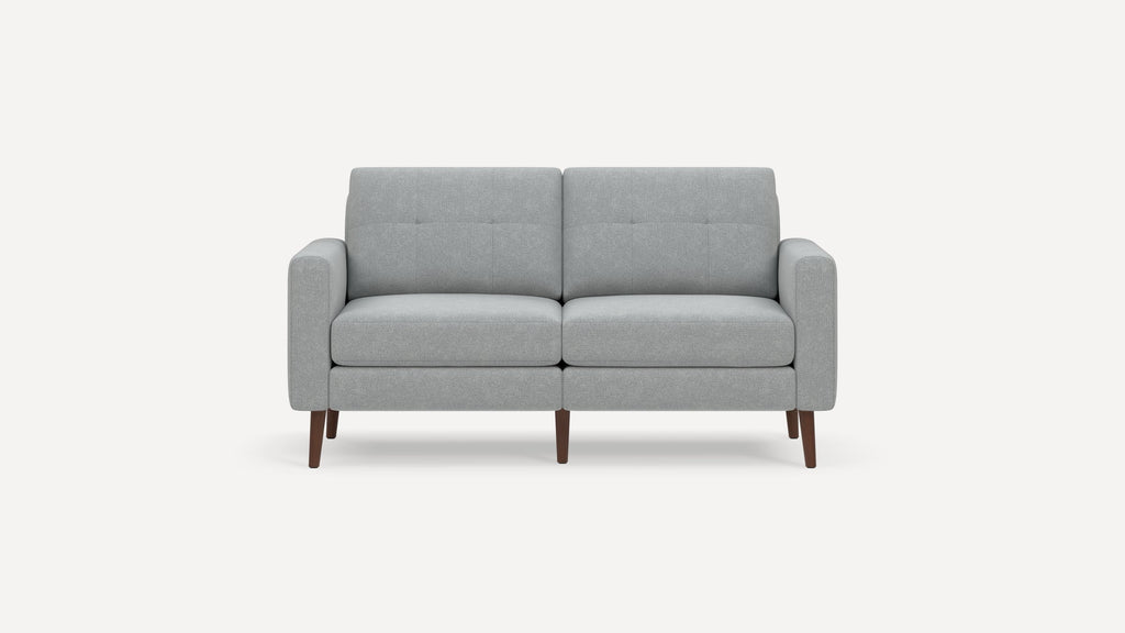 Light gray two-seater sofa with tufted back cushions, rounded armrests, and tapered wooden legs on a white background.