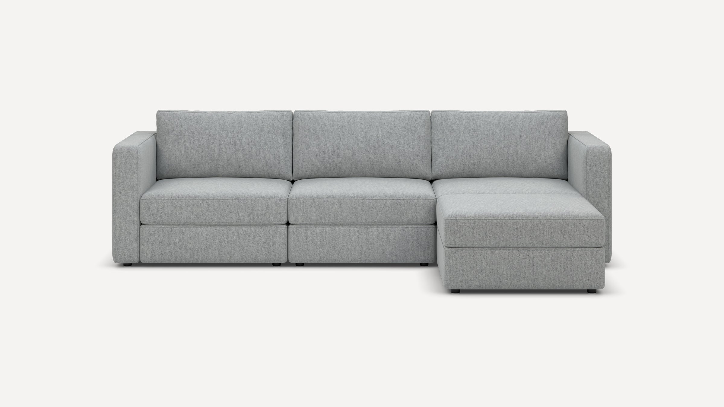 Light gray fabric sectional sofa with clean lines, three seat cushions, three back cushions, and a right-side chaise lounge.