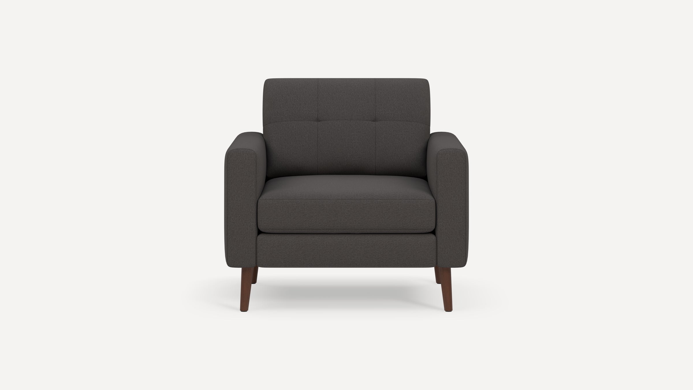 Modern dark gray fabric armchair with tufted backrest and wooden tapered legs, viewed from front.