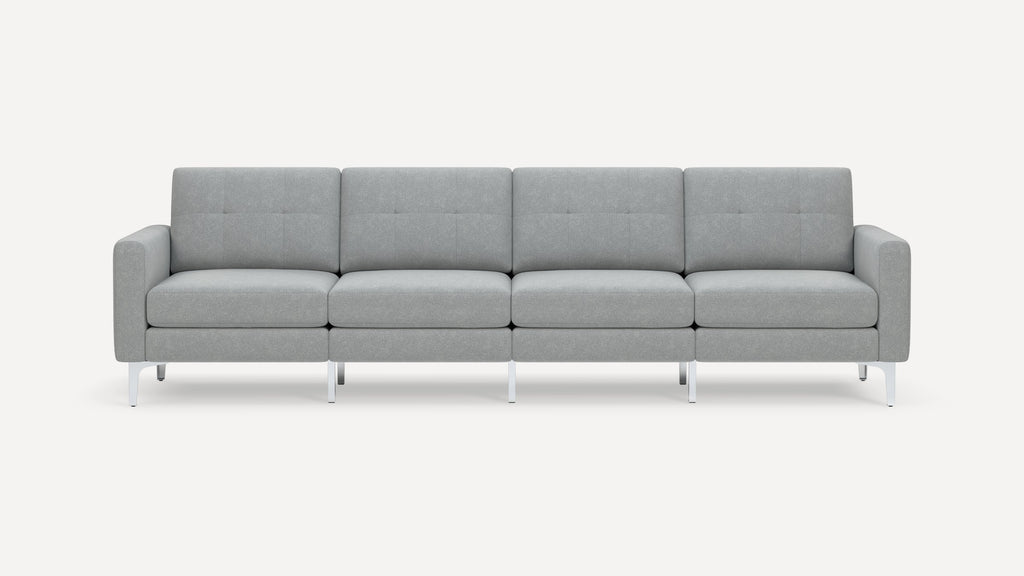 Modern four-seat sofa with light gray upholstery, tufted back cushions, square arms, and slim chrome legs on white background.