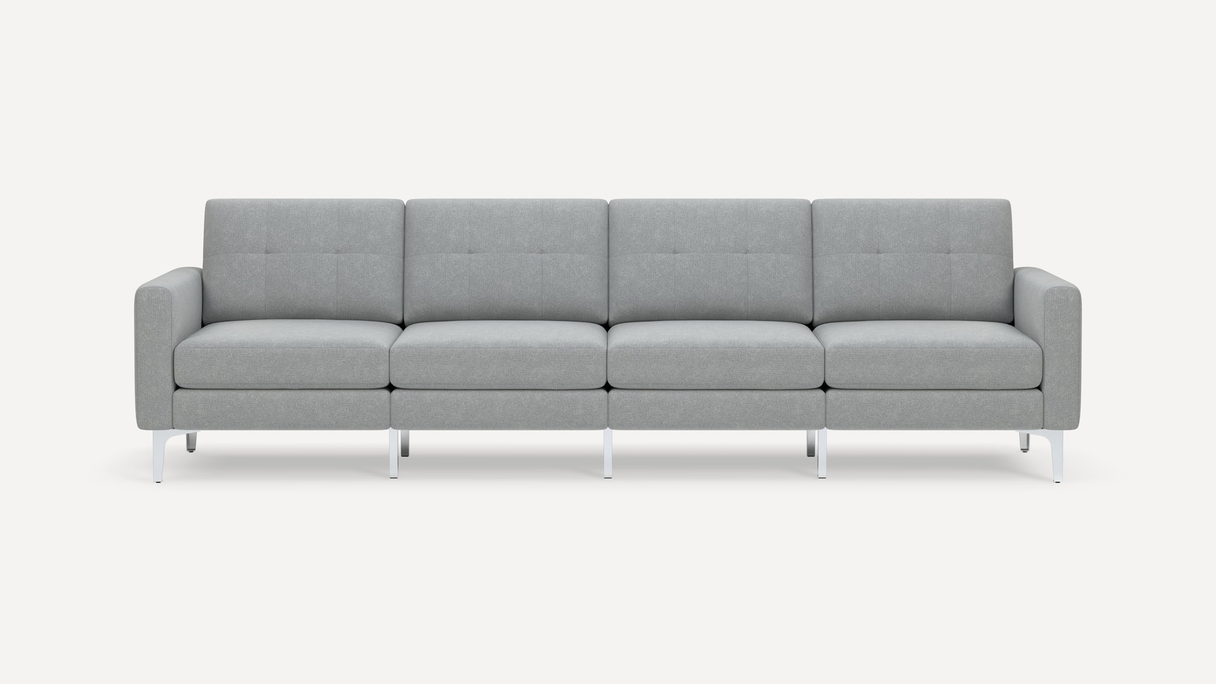 Modern four-seat sofa with light gray upholstery, tufted back cushions, square arms, and slim chrome legs on white background.