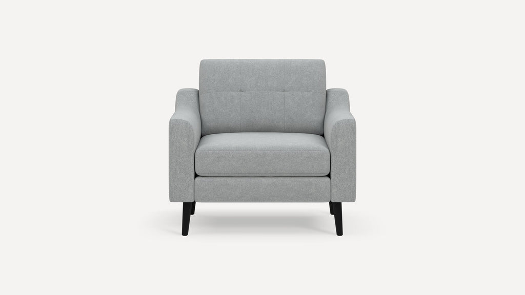 Front view of a modern light gray upholstered armchair with square arms and black tapered wooden legs.