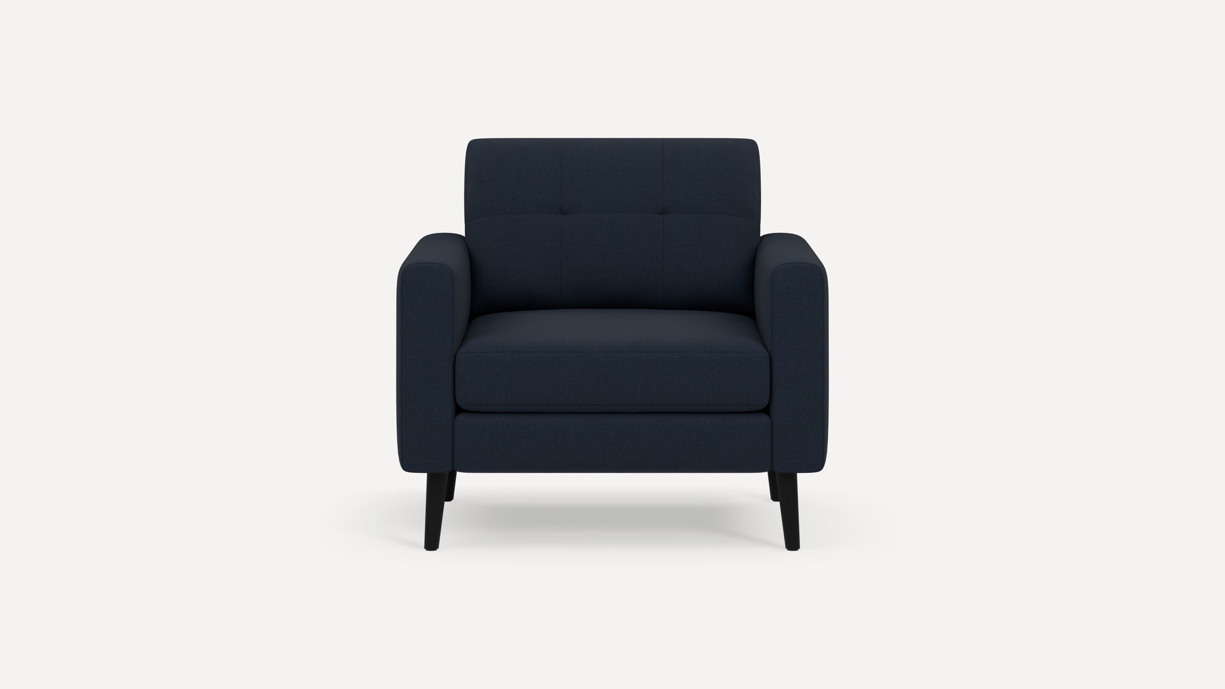 Modern navy blue upholstered armchair with tufted backrest, cushioned seat, and black wooden legs, front view.