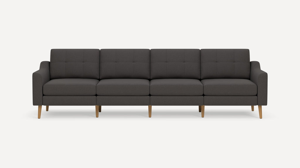 Four-seat modern dark gray fabric sofa with wooden legs and tufted back cushions, featuring slim armrests.