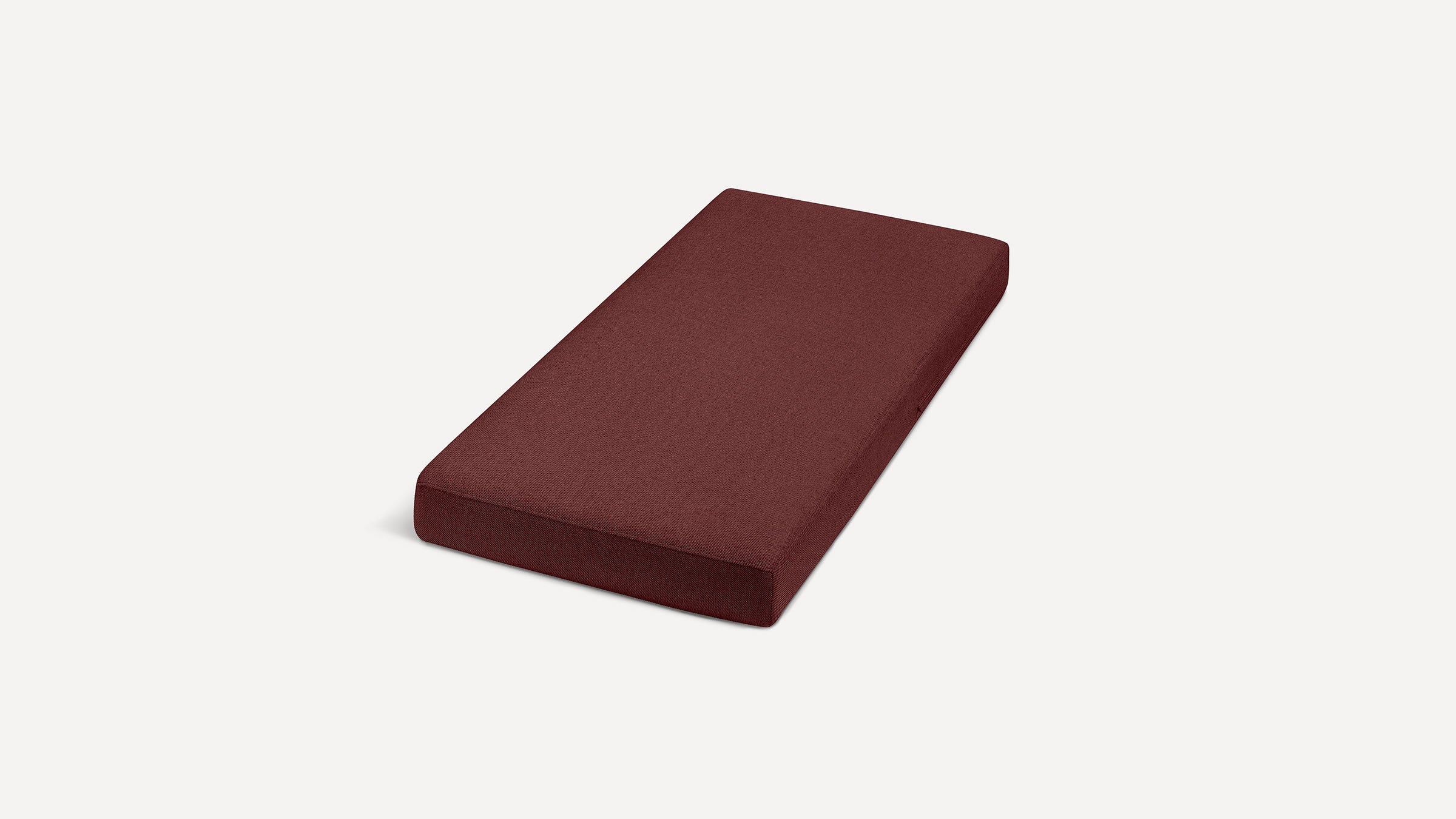 a red cushion on a white background