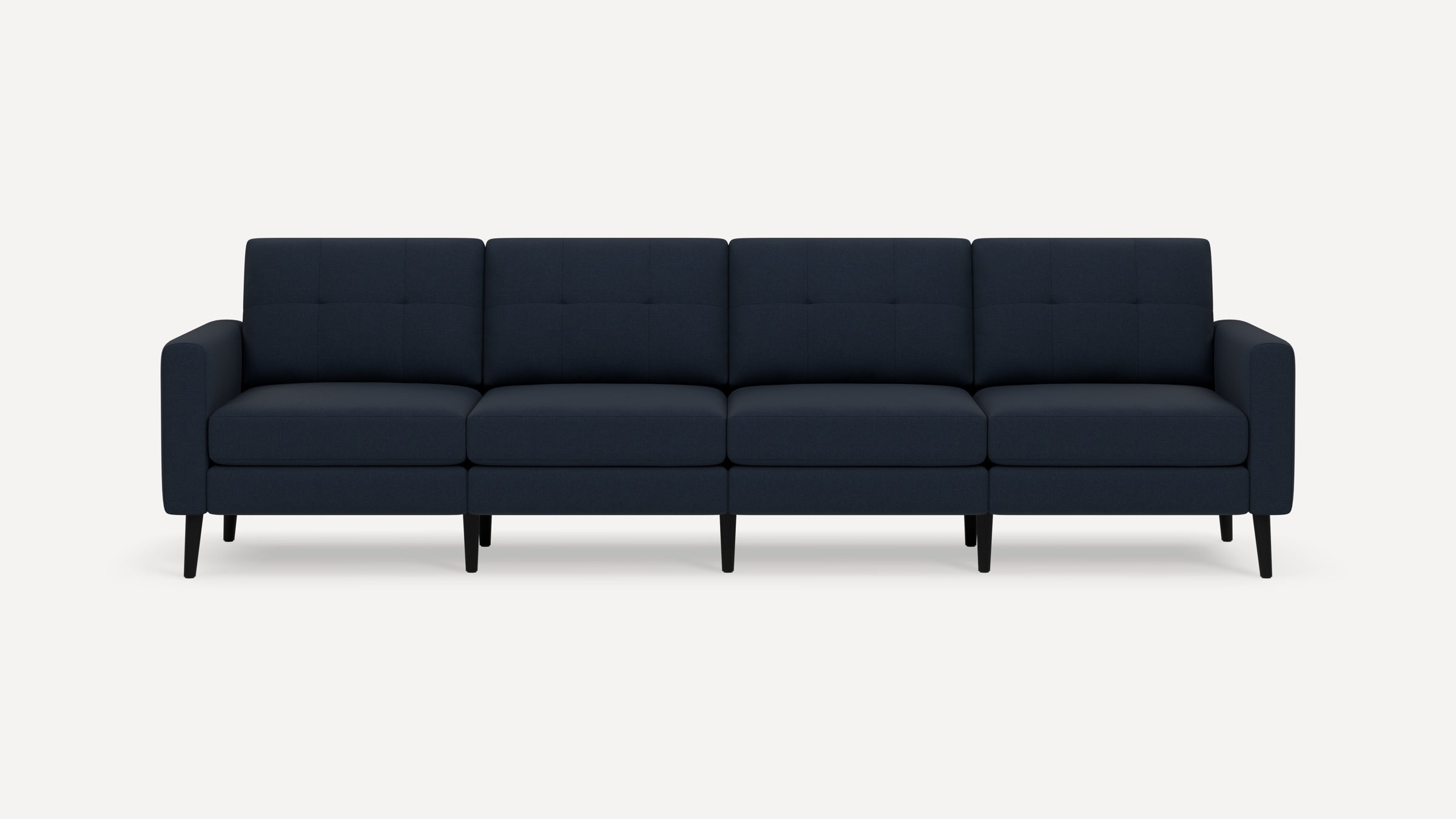 Modern navy blue four-seater sofa with tufted cushions and slim black wooden legs, shown against a plain white background.