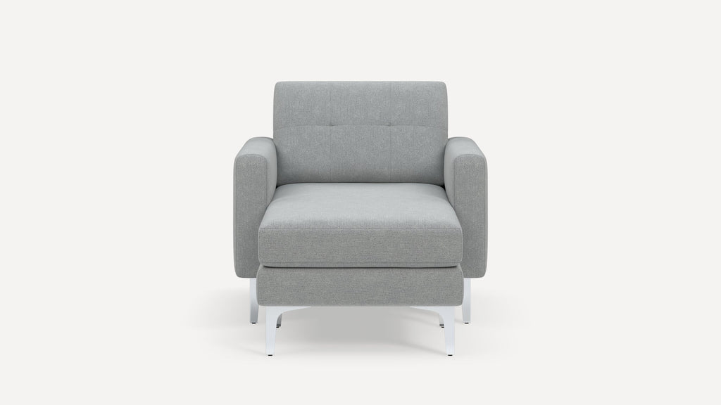 Modern gray upholstered armchair with cushioned seat and backrest, featuring clean lines and white metal legs.