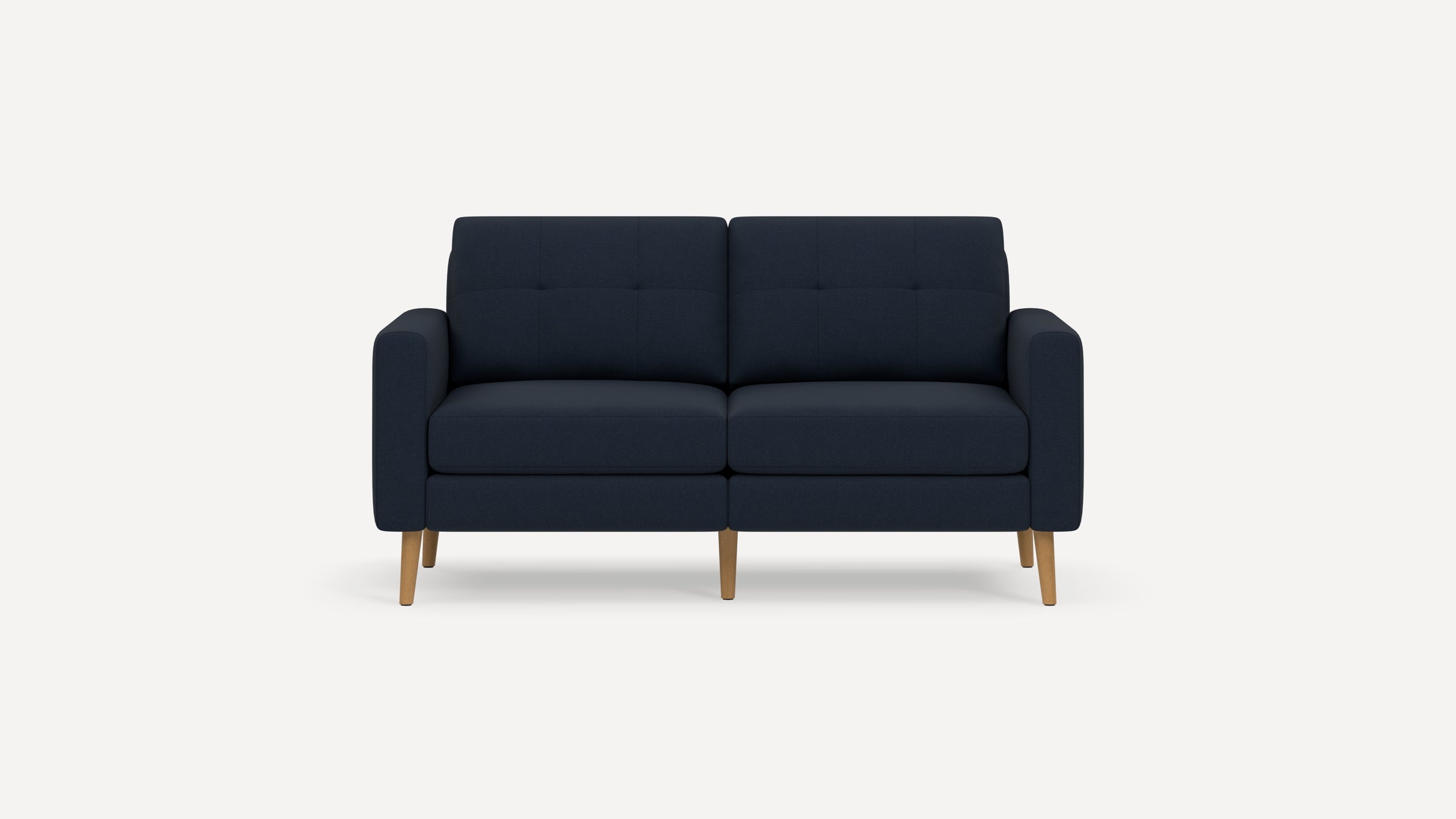 Dark blue modern two-seater sofa with tufted cushions and wooden legs on a plain white background.
