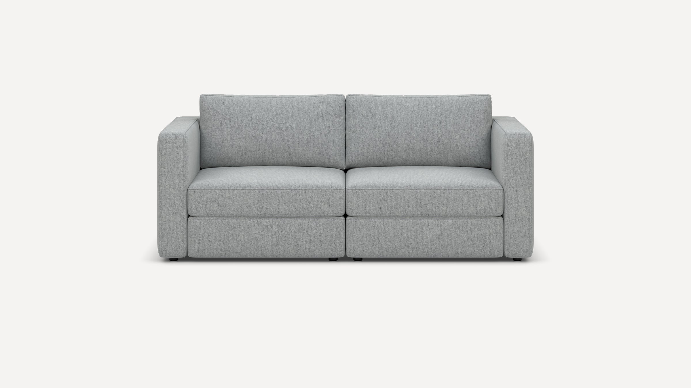 Modern two-seater sofa upholstered in light gray fabric with clean lines, thick cushions, and square armrests, set against a white background.