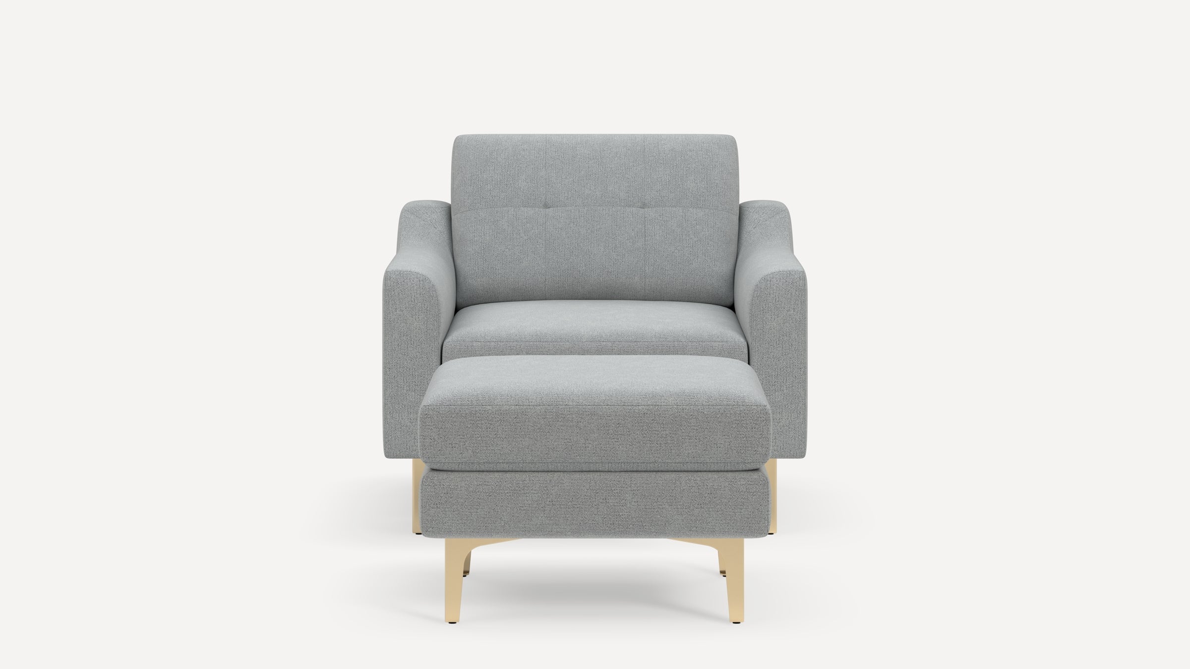Front view of a modern light gray fabric armchair with a matching ottoman and light wood legs on a white background.