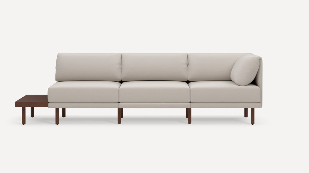 Modern beige sectional sofa with clean lines, wooden legs, and an integrated wooden side table on the left side.