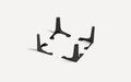Set of four black metal furniture legs with mounting holes, designed for sturdy table or cabinet support.