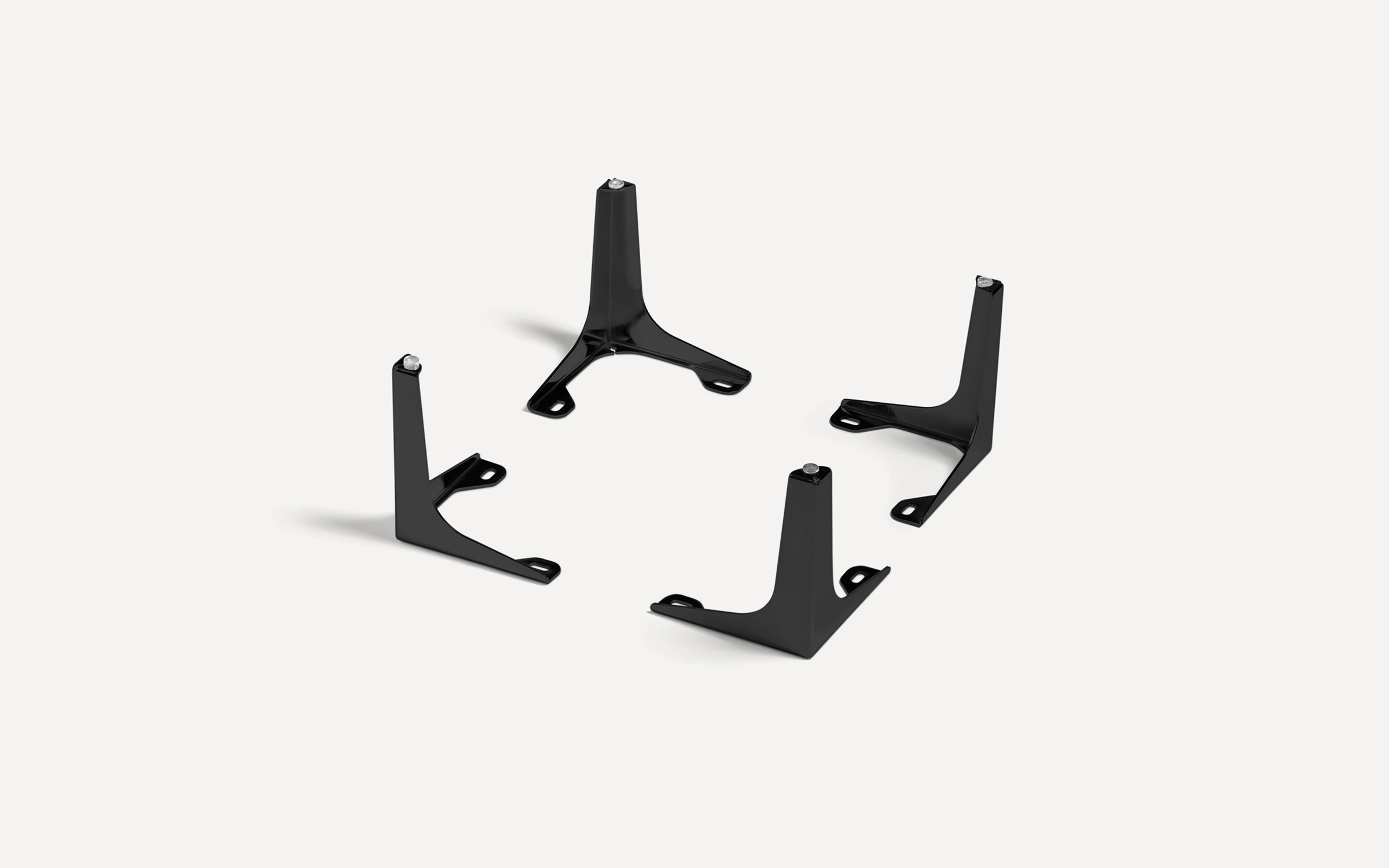 Set of four black metal furniture legs with mounting holes, designed for sturdy table or cabinet support.