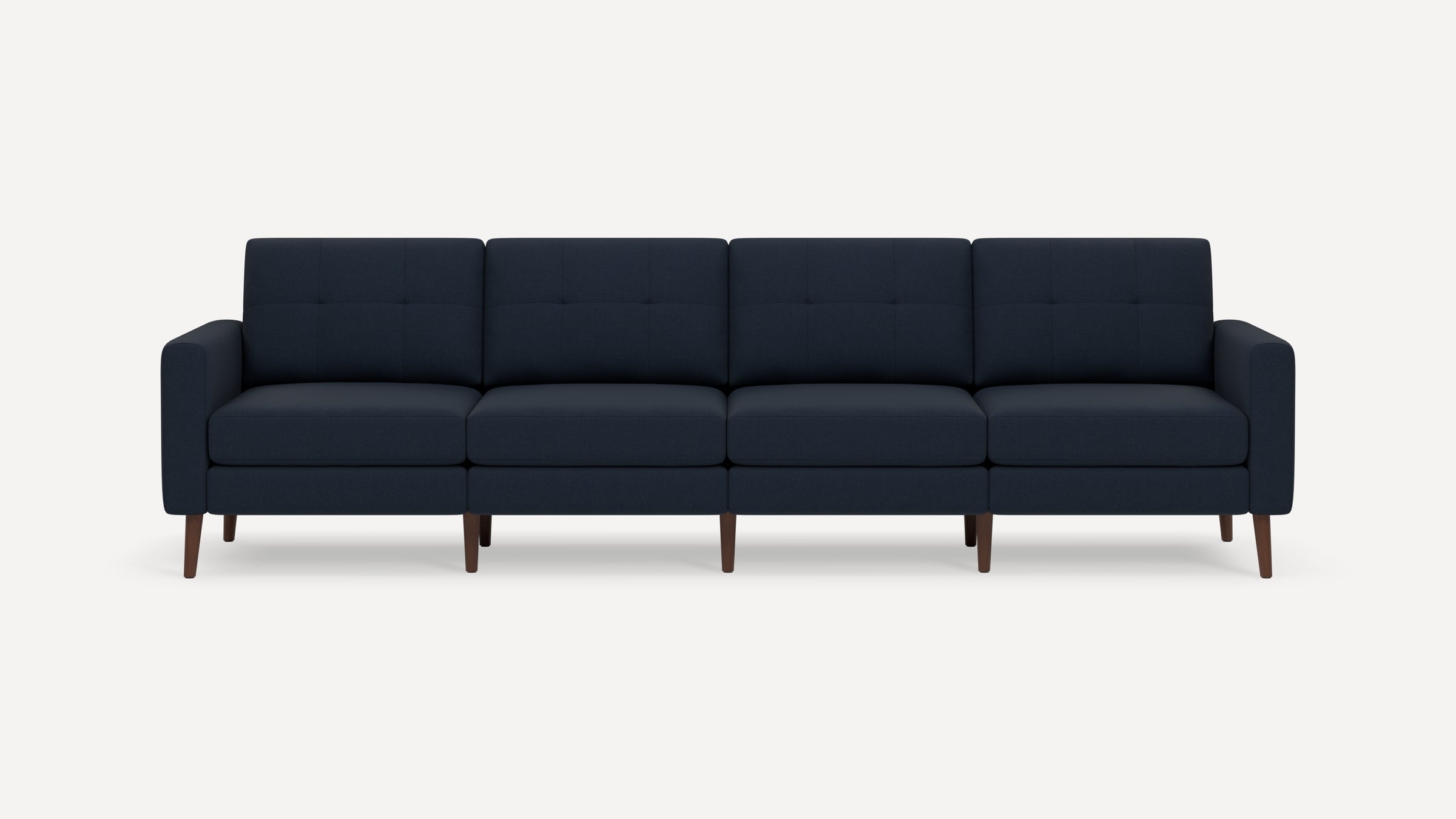 Four-seater navy blue modern sofa with tufted cushions and wooden legs, featuring clean lines and armrests on each side.