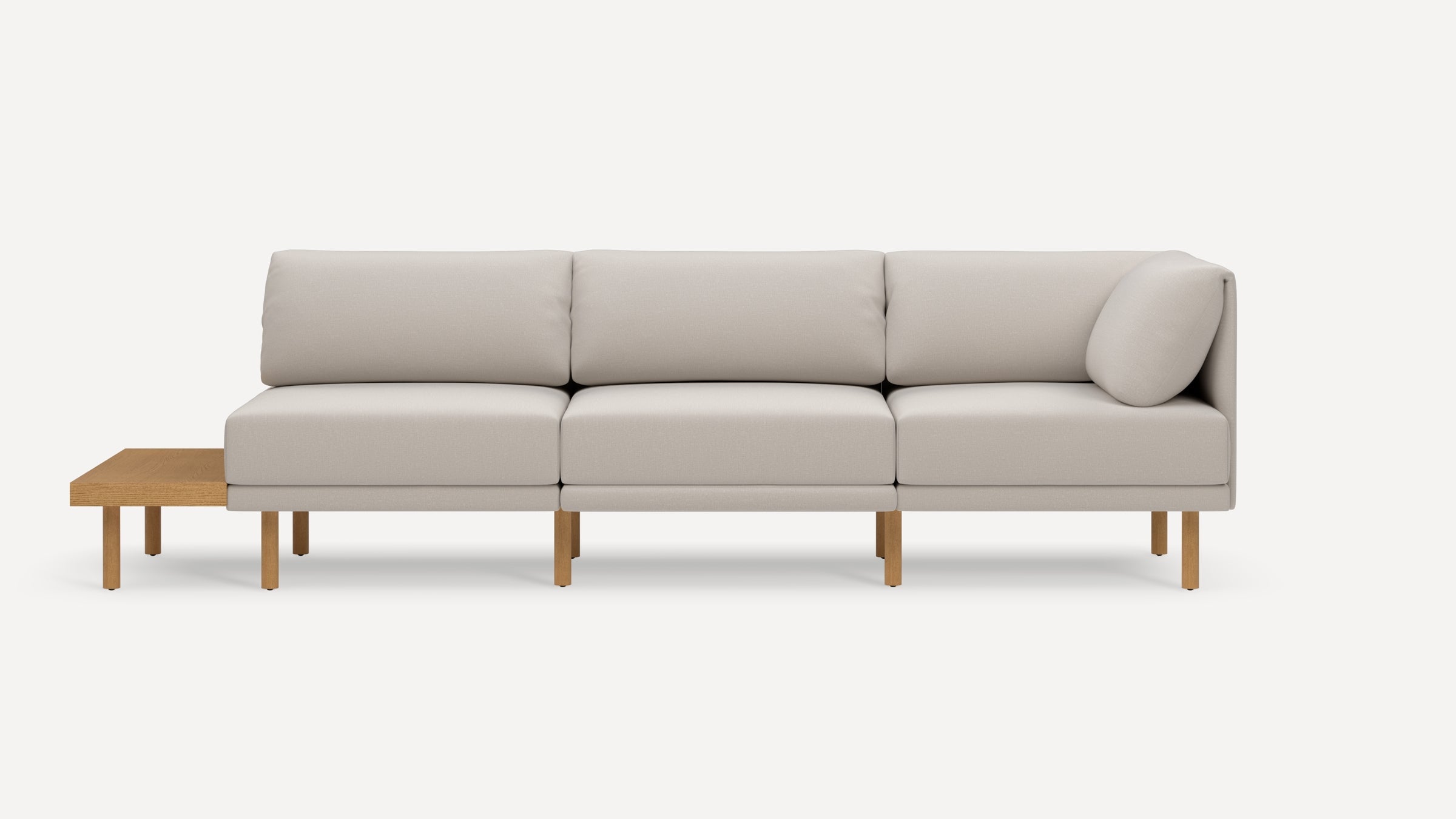 Modern beige sectional sofa with wooden legs and an attached wooden side table on the left side, shown against a white background.