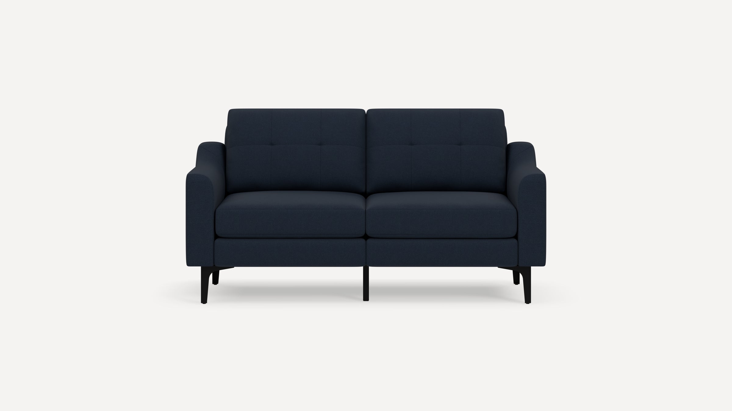 Dark blue modern two-seater sofa with tufted back cushions, slim black legs, and gently curved armrests on a white background.