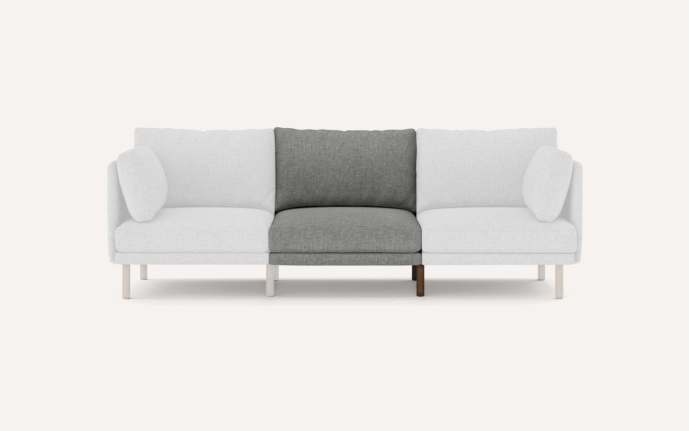 Modern three-seater sofa with white outer sections and a contrasting dark gray center cushion, featuring sleek wooden legs.
