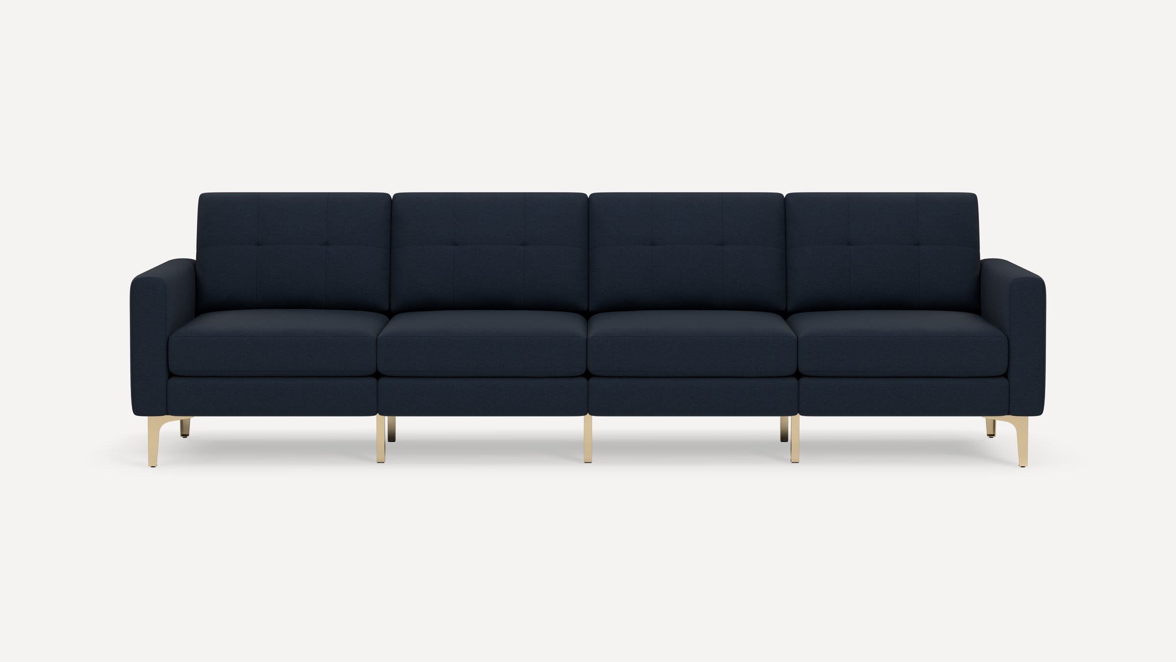 Modern four-seater navy blue fabric sofa with tufted back cushions and sleek light wooden legs on a white background.