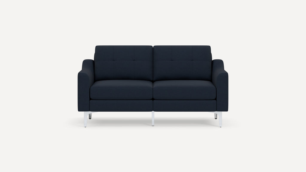 Modern two-seater navy blue fabric sofa with tufted back cushions and sleek white metal legs on a plain white background.
