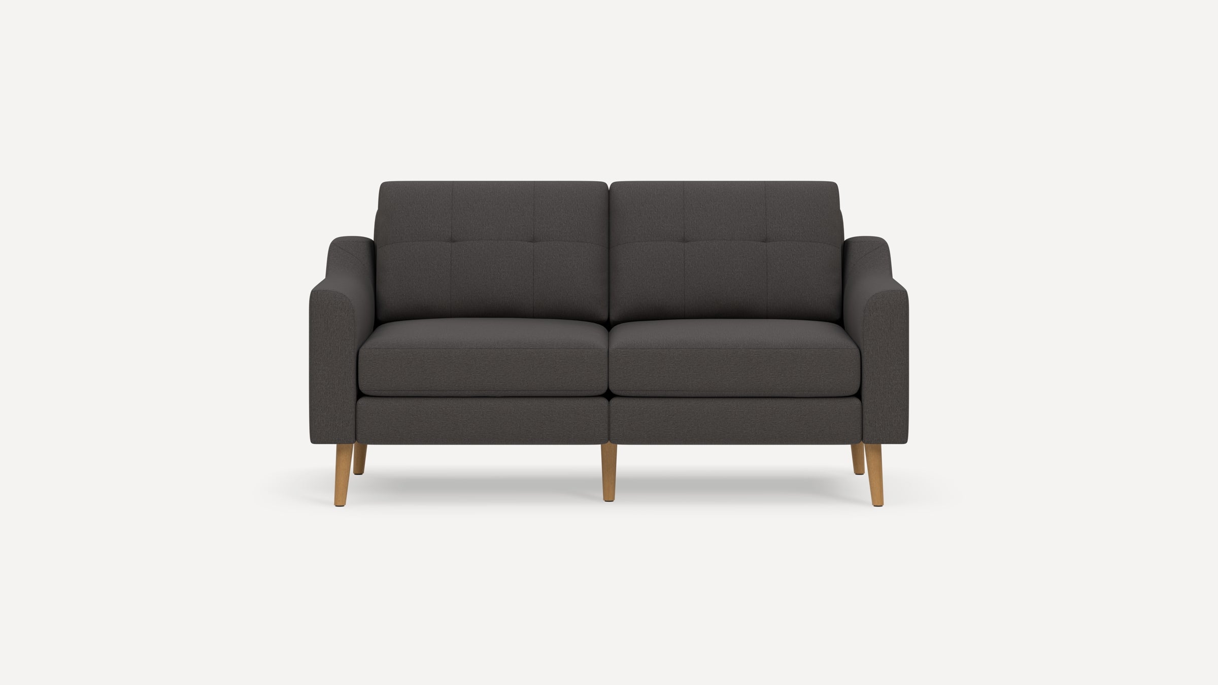Dark gray modern two-seater sofa with wooden legs and tufted back cushions, against a plain white background.