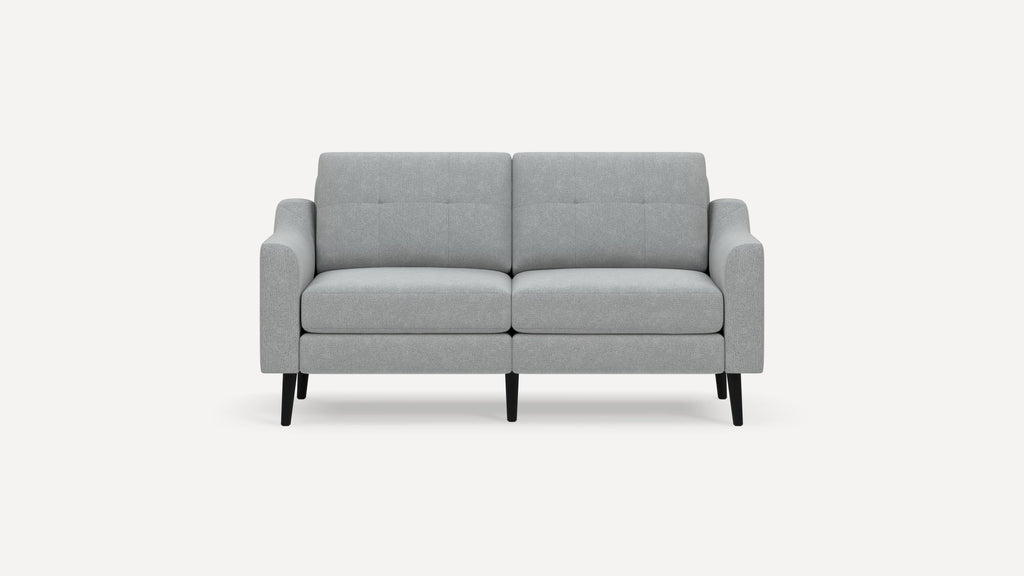 Light gray two-seater sofa with a modern design, straight arms, tufted back cushions, and black tapered legs.