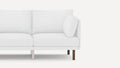 Modern white fabric sofa with cushioned seats, backrests, and a single matching pillow on wooden legs.