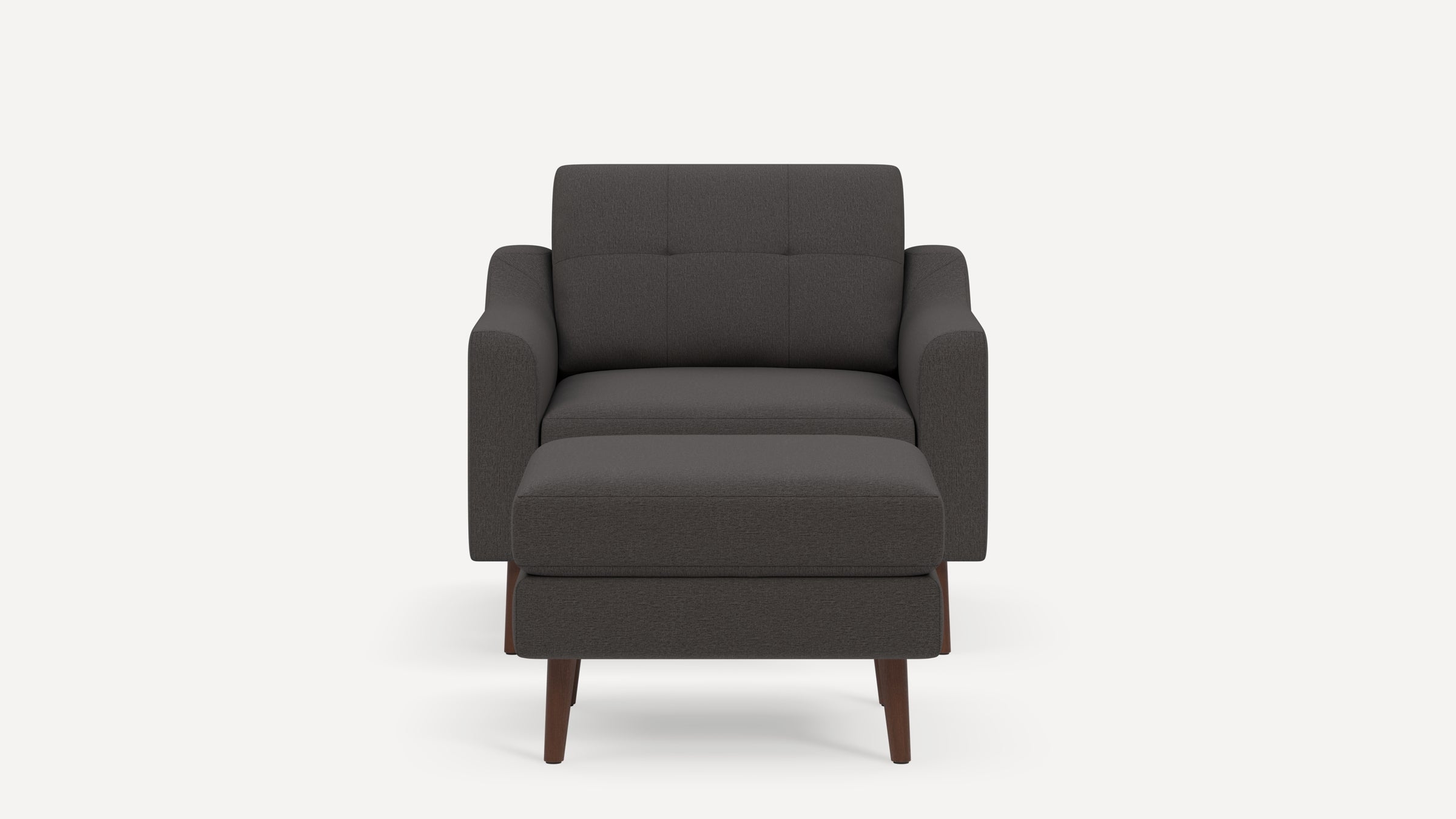 Front view of a dark gray upholstered armchair with matching ottoman and wooden legs on a plain background.