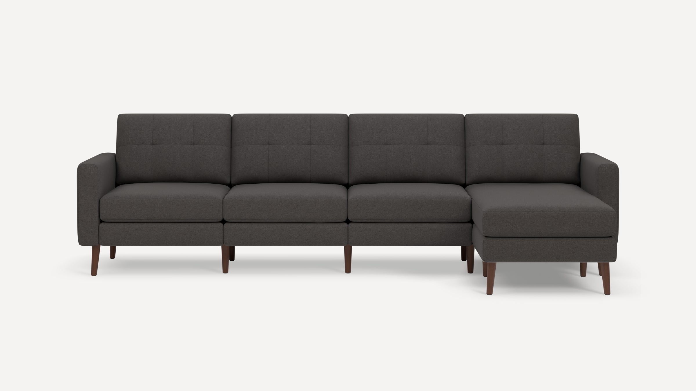 Dark gray modern sectional sofa with mid-century wooden legs and tufted back cushions, featuring a right-side chaise lounge.
