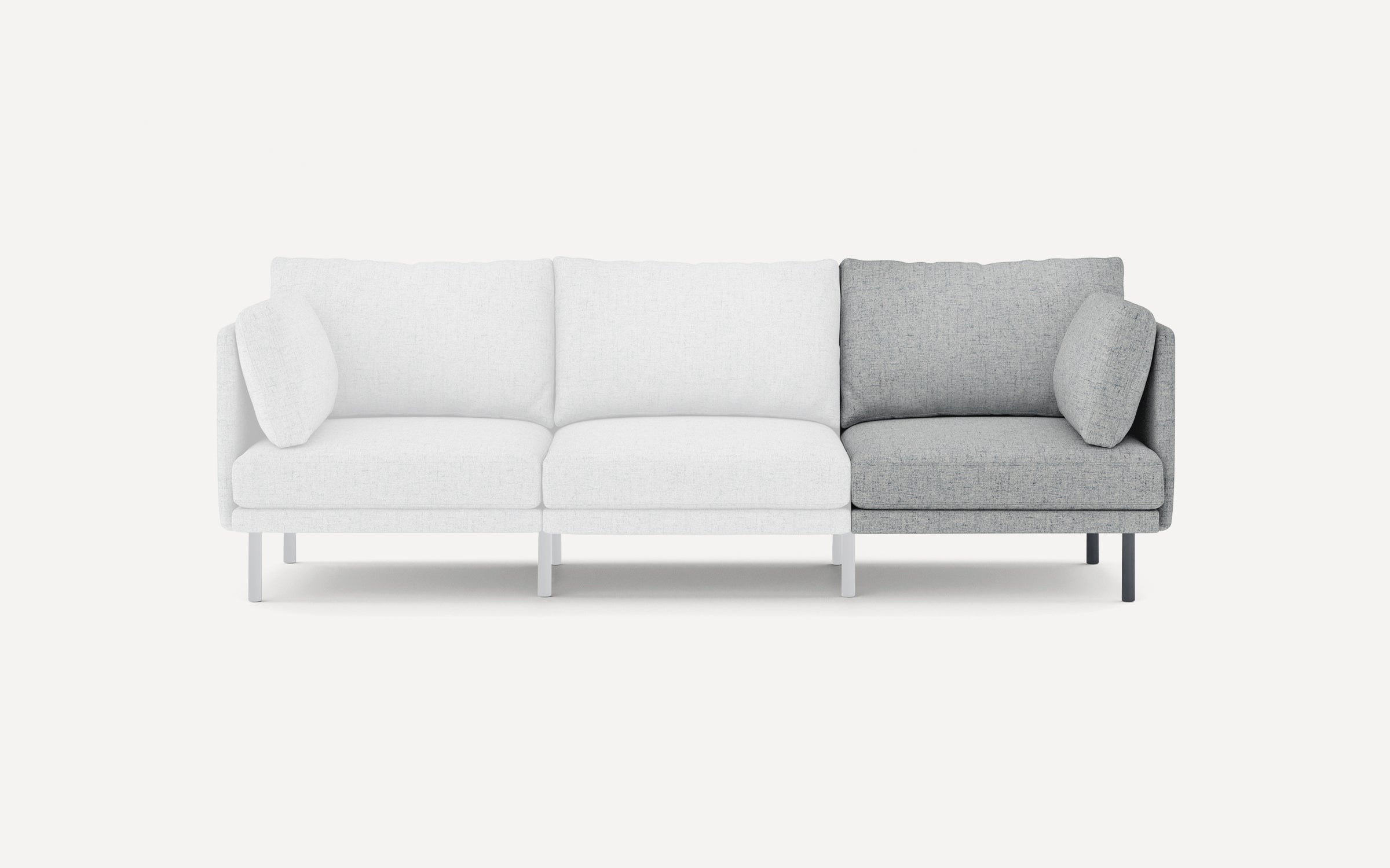 Modern three-seater sofa with clean lines, featuring two white fabric seats and one light gray fabric seat with matching cushions.
