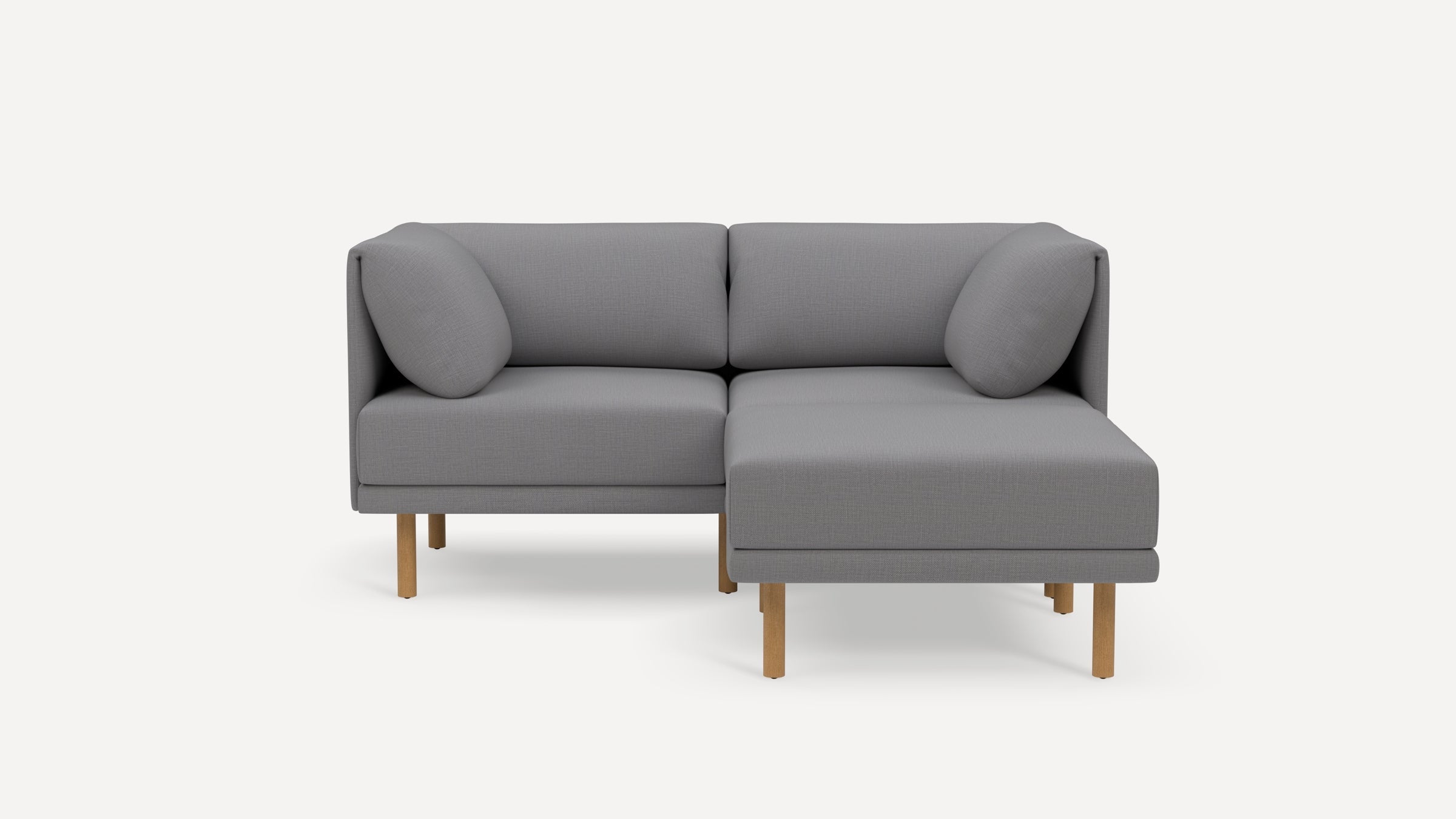Modern gray fabric sectional sofa with wooden legs, featuring two seat cushions, two back cushions, and two side pillows.