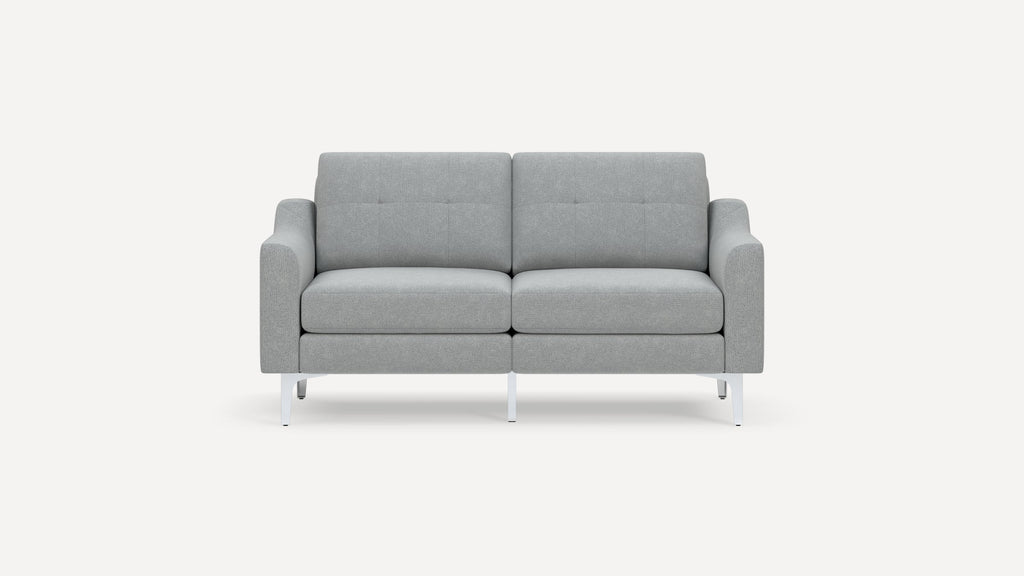 Modern light gray fabric loveseat sofa with tufted back cushions and slim white metal legs on white background.