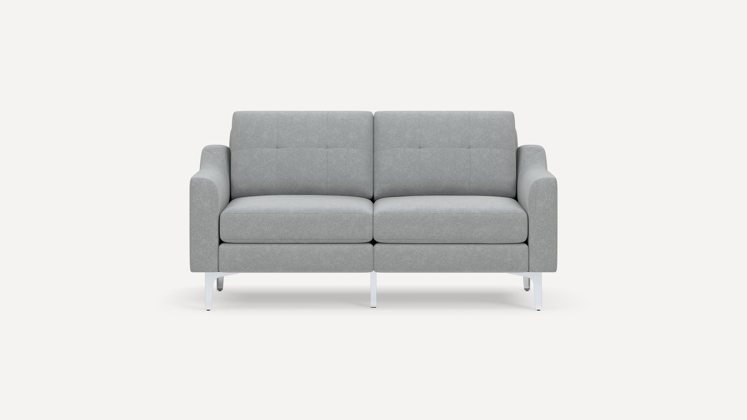 Modern light gray fabric loveseat sofa with tufted back cushions and slim white metal legs on white background.