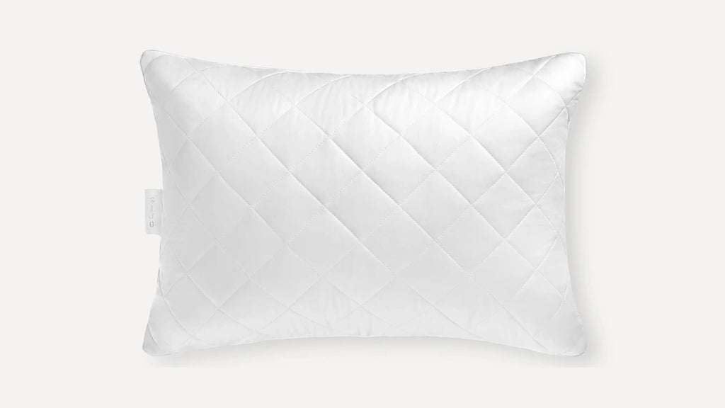 white pillow with a diamond pattern on the front