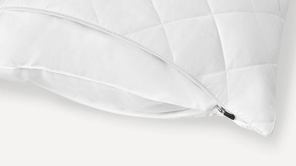 a white pillow with a zippered cover on it