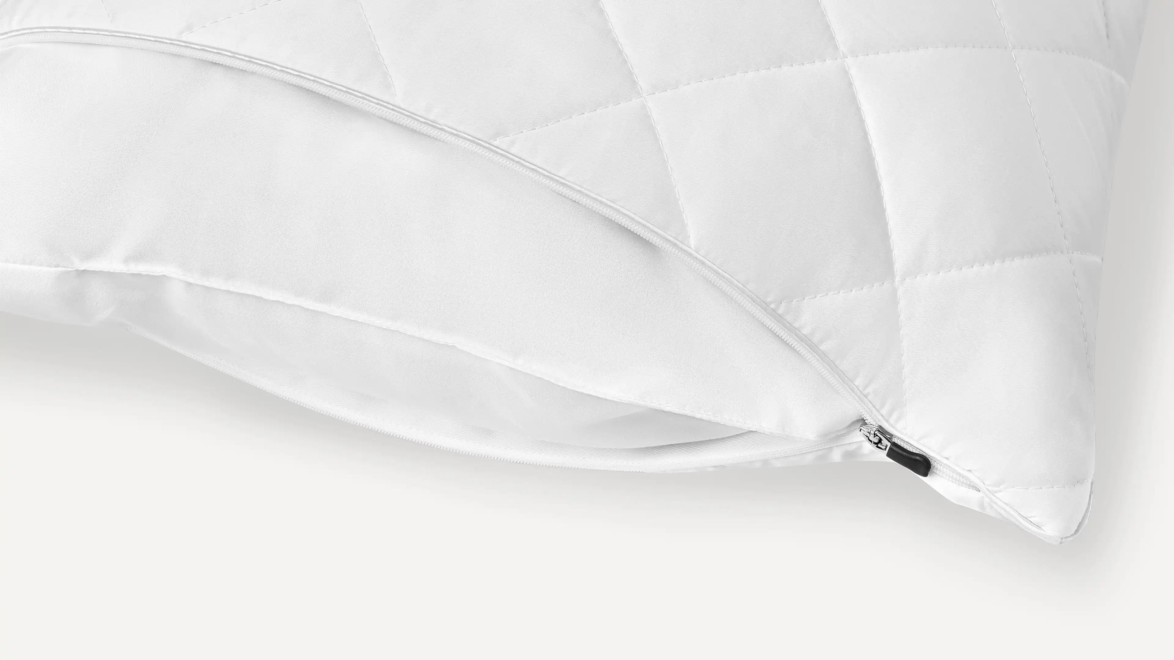 a white pillow with a zippered cover on it