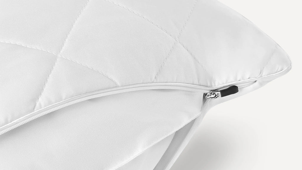 a white pillow with a zippered cover on it