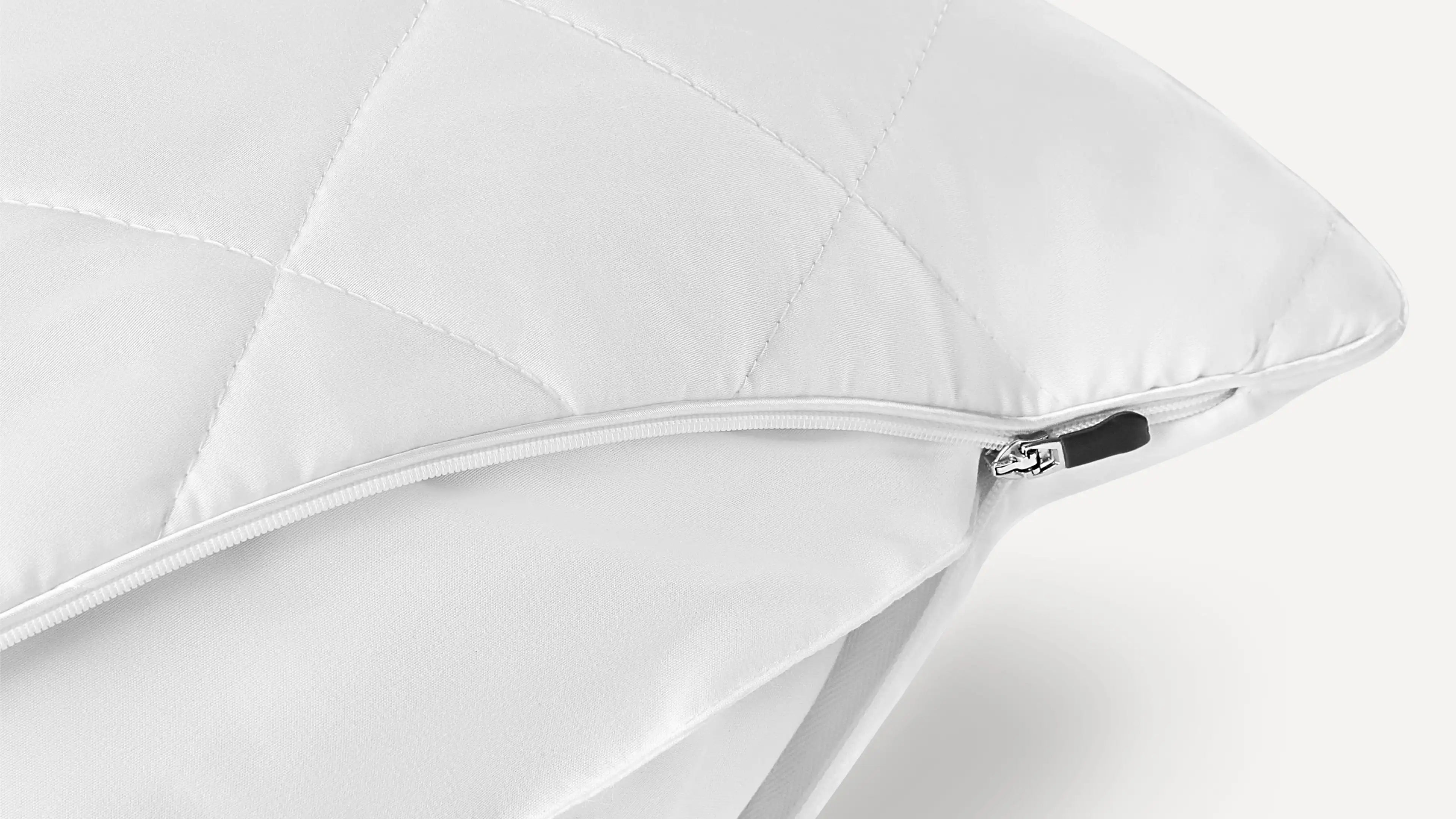 a white pillow with a zippered cover on it