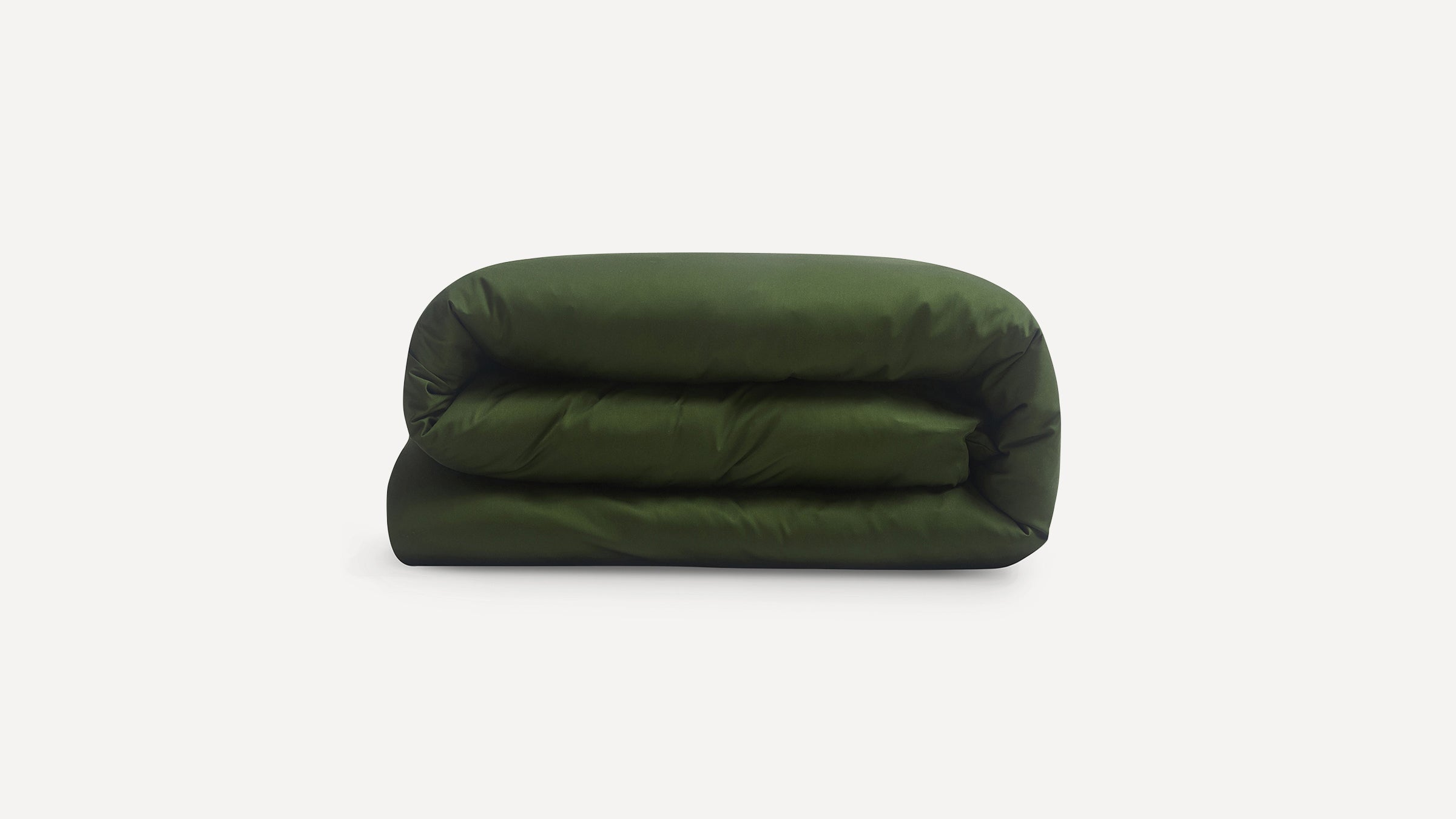 Dark green folded comforter or duvet against a white background, showcasing its smooth, plush fabric.