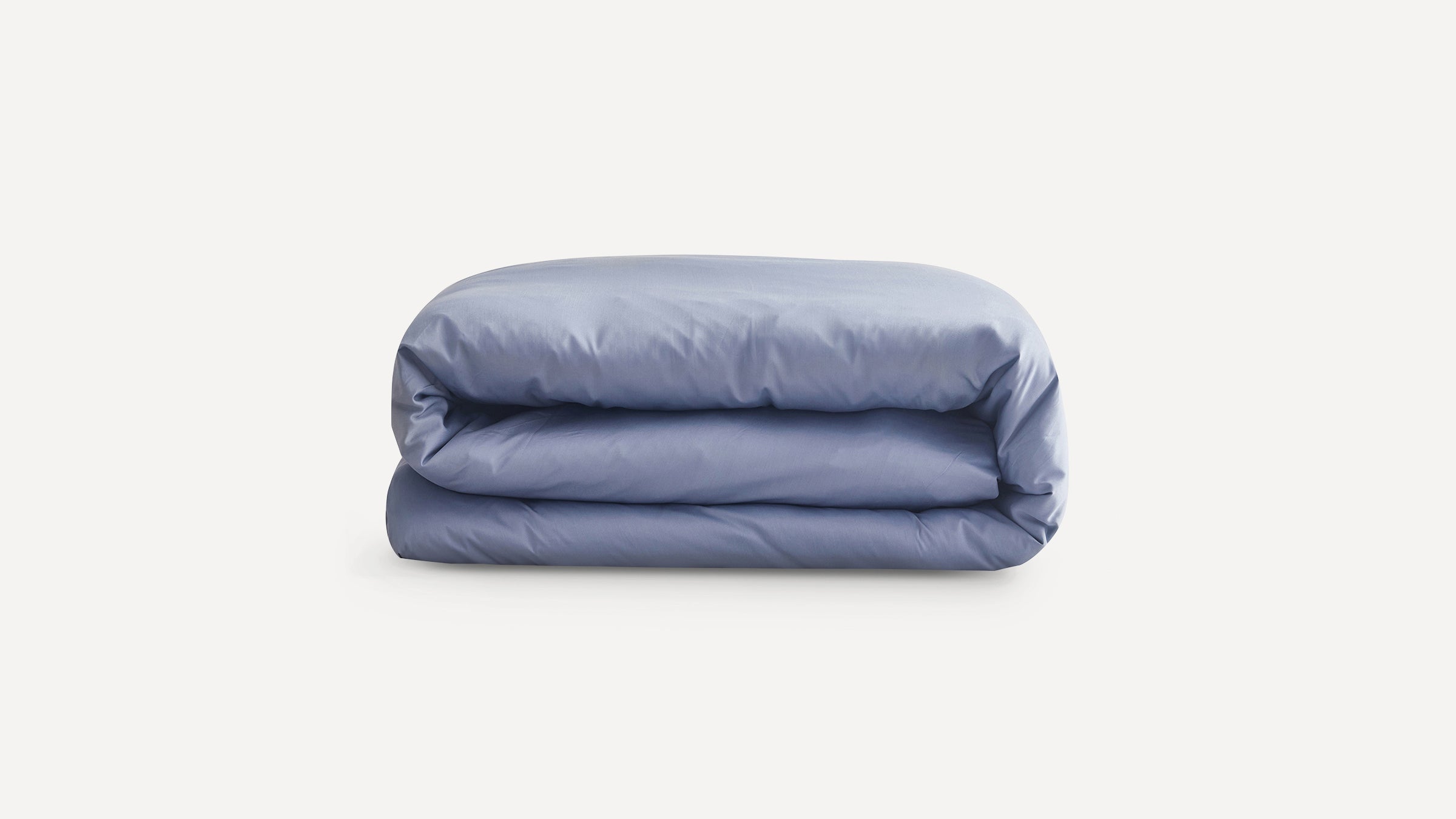Light blue folded comforter or duvet with a smooth fabric texture on a plain white background.