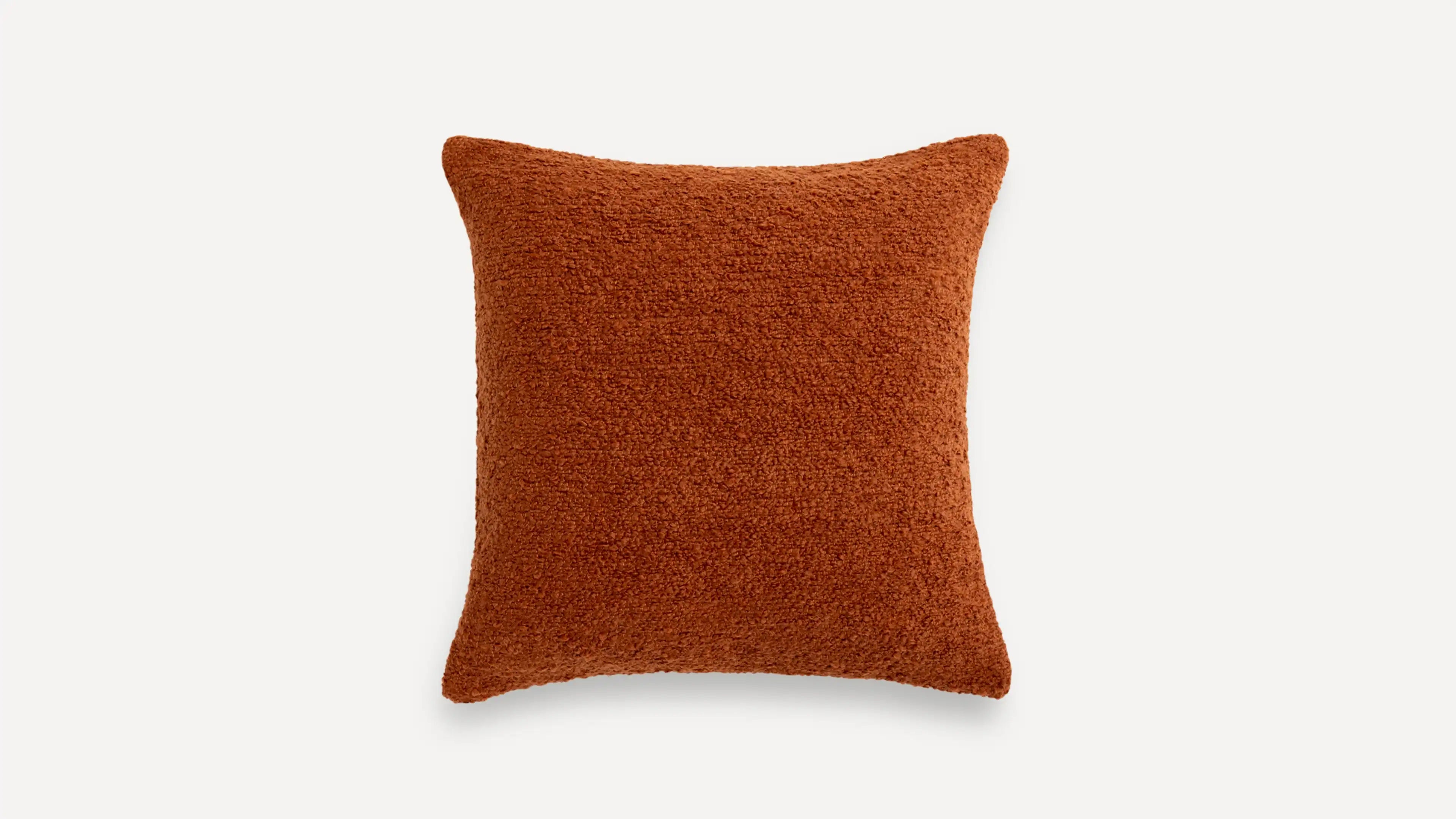 a burnt orange pillow with a textured design