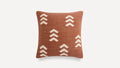 a brown and white pillow with a geometric design