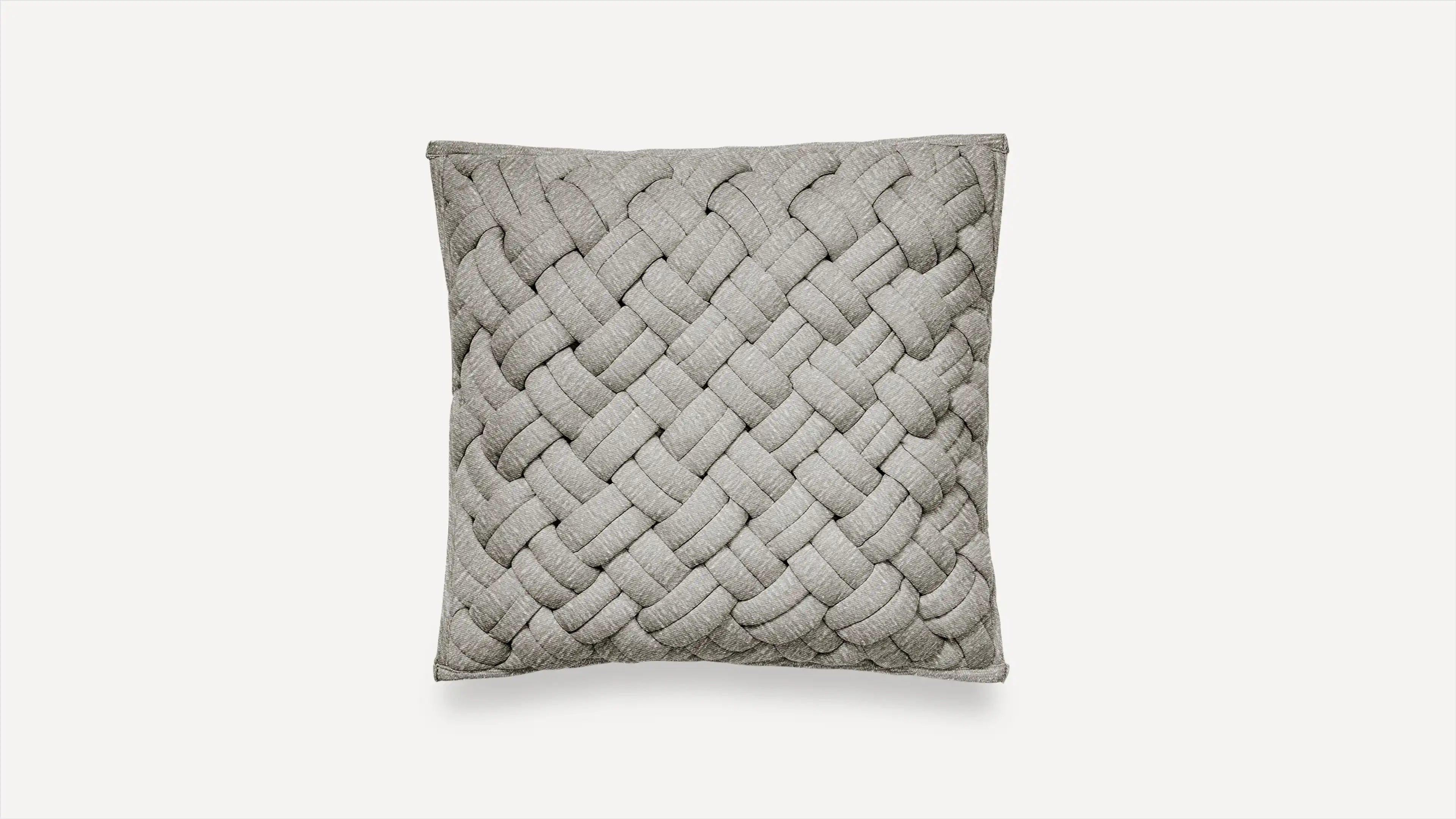 the woven cushion is made from light gray linen and features a braid design