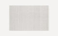 Rectangular light gray area rug with subtle small-scale woven chevron pattern, simple and modern design, flat weave texture.