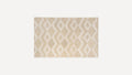 Rectangular beige rug with raised diamond and zigzag pattern, featuring a soft, plush texture.