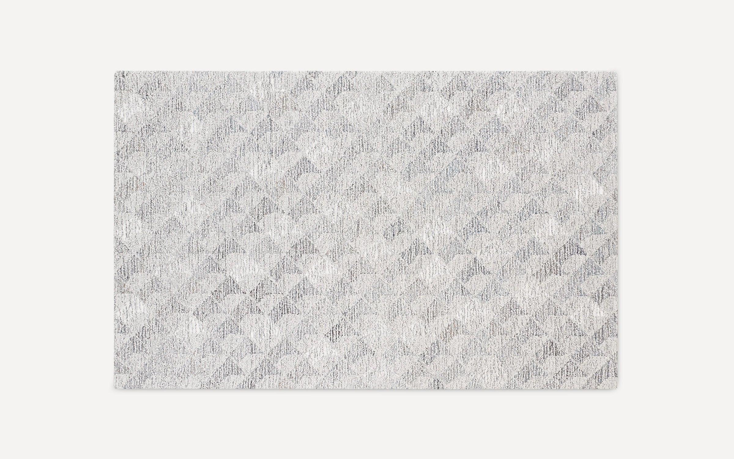 Rectangular area rug with a textured geometric pattern in various shades of gray and white, featuring a soft, plush surface.
