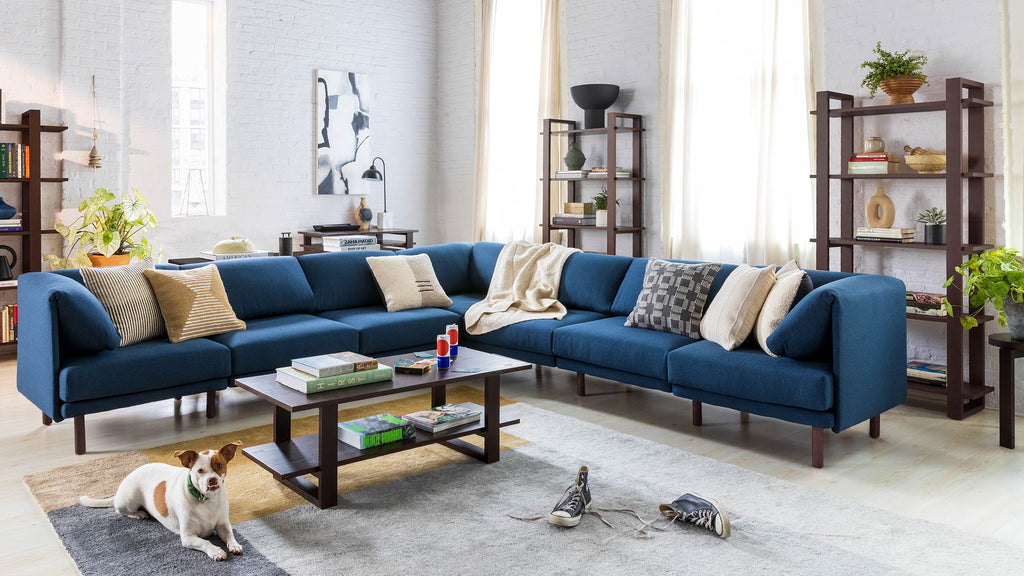 a room with a blue couch and various decorations